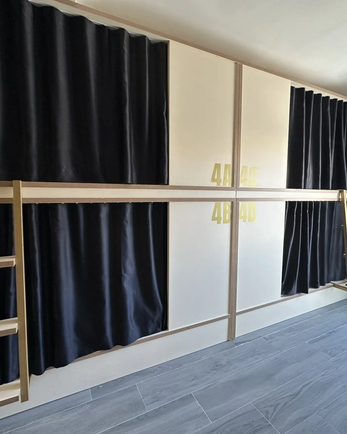 Habitación compartida mixta con literas de madera y cortinas